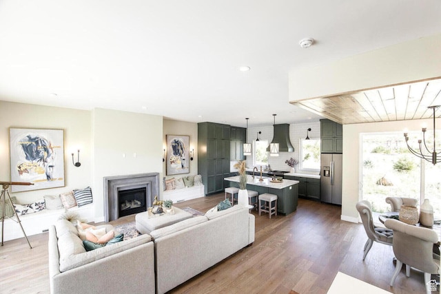 386 W Ascent Dr Unit 257, Hideout, UT 84036 - living area with a fireplace, a notable chandelier, and wood finished floors