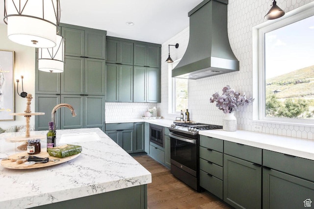 386 W Ascent Dr Unit 257, Hideout, UT 84036 - kitchen featuring decorative backsplash, stainless steel appliances, pendant lighting, a sink, and exhaust hood