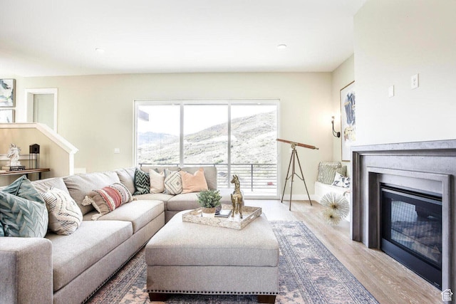 386 W Ascent Dr Unit 257, Hideout, UT 84036 - living room featuring baseboards, a mountain view, wood finished floors, and a glass covered fireplace