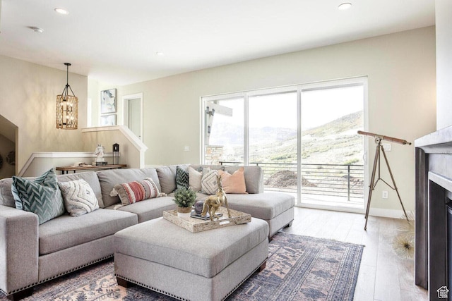 386 W Ascent Dr Unit 257, Hideout, UT 84036 - living room with a notable chandelier, recessed lighting, a fireplace, baseboards, and light wood-style floors