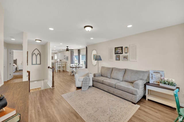 living area featuring recessed lighting, ceiling fan, light wood-style flooring, and baseboards