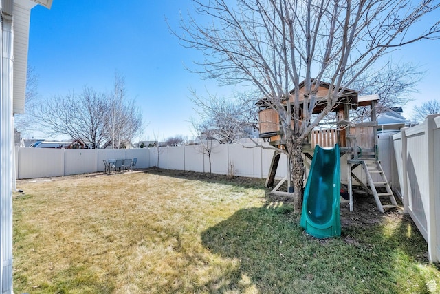 view of yard with a fenced backyard and a playground