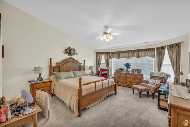 bedroom featuring light carpet and a ceiling fan