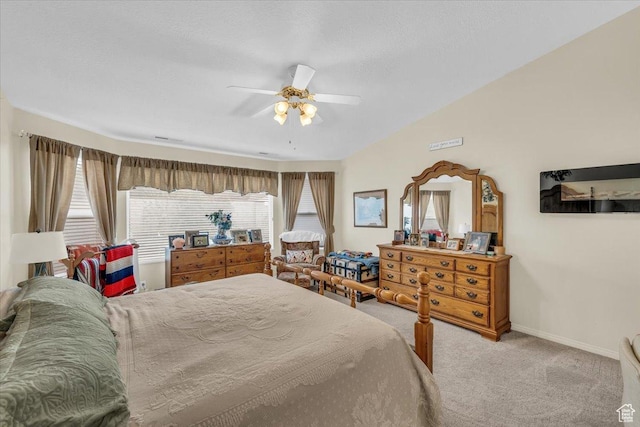 carpeted bedroom featuring baseboards, vaulted ceiling, and a ceiling fan