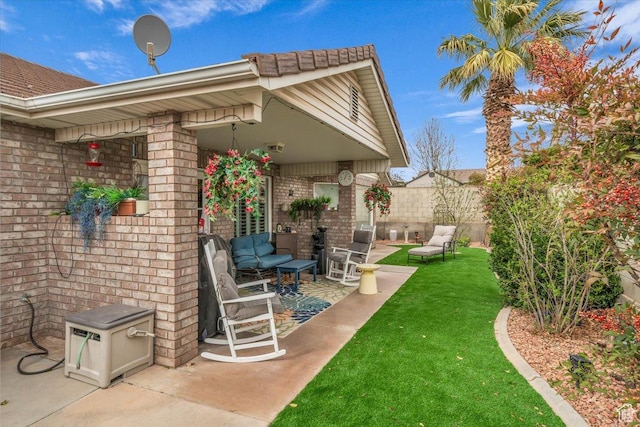 exterior space featuring outdoor lounge area and fence