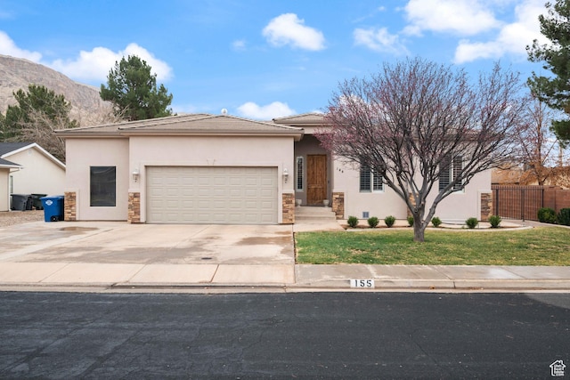155 W 960 S, Hurricane, UT 84737 - view of front of property with a garage, stucco siding, stone siding, fence, and driveway