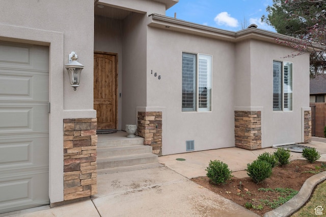 155 W 960 S, Hurricane, UT 84737 - view of exterior entry with stucco siding, stone siding, and visible vents