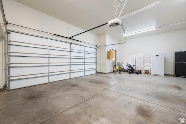 155 W 960 S, Hurricane, UT 84737 - garage with a garage door opener and freestanding refrigerator