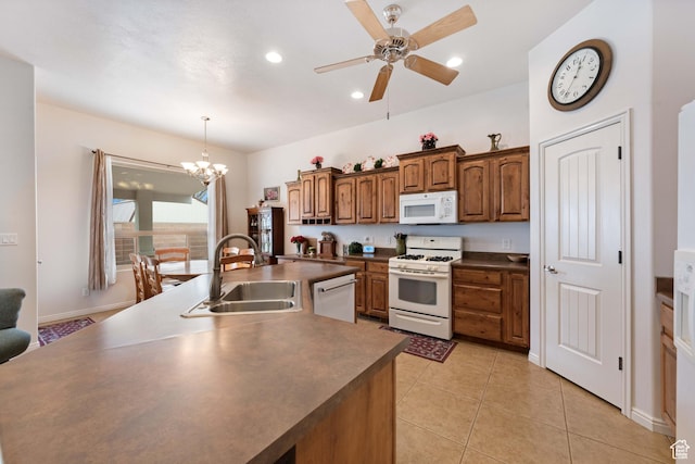 155 W 960 S, Hurricane, UT 84737 - kitchen with light tile patterned floors, a sink, dark countertops, white appliances, and ceiling fan with notable chandelier