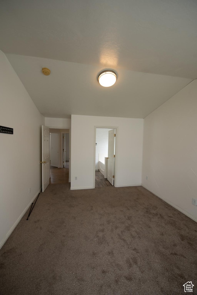 carpeted empty room featuring baseboards