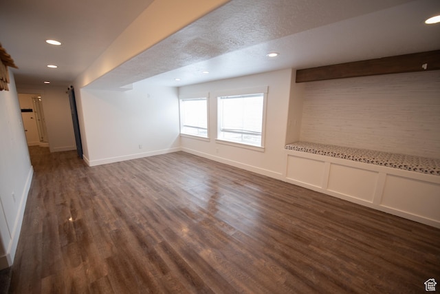 unfurnished living room featuring baseboards, recessed lighting, and dark wood-type flooring