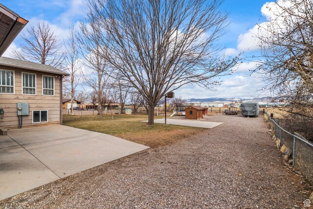 79 S 250 E, Aurora, UT 84620 - view of yard featuring a fenced backyard, a patio, driveway, and an outdoor structure