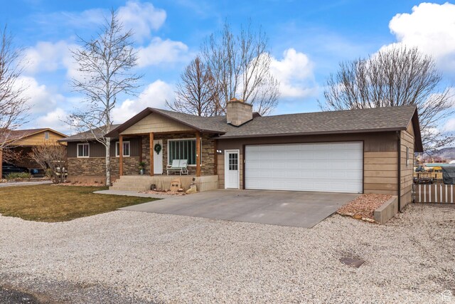 79 S 250 E, Aurora, UT 84620 - ranch-style home featuring driveway, stone siding, a chimney, roof with shingles, and an attached garage