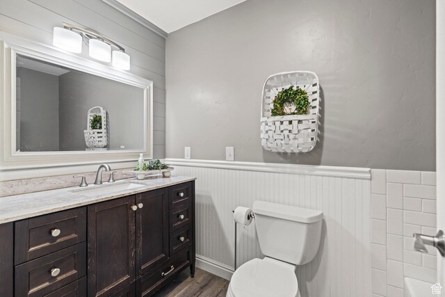 79 S 250 E, Aurora, UT 84620 - bathroom with wood finished floors, wainscoting, vanity, and toilet