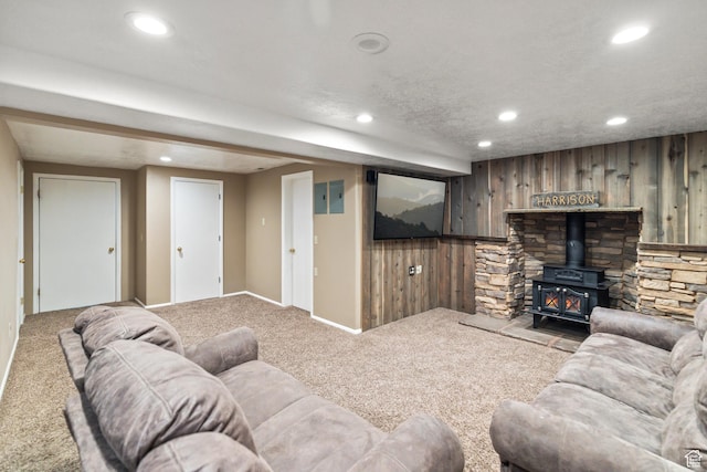 79 S 250 E, Aurora, UT 84620 - carpeted living area with recessed lighting, a wood stove, wooden walls, and baseboards