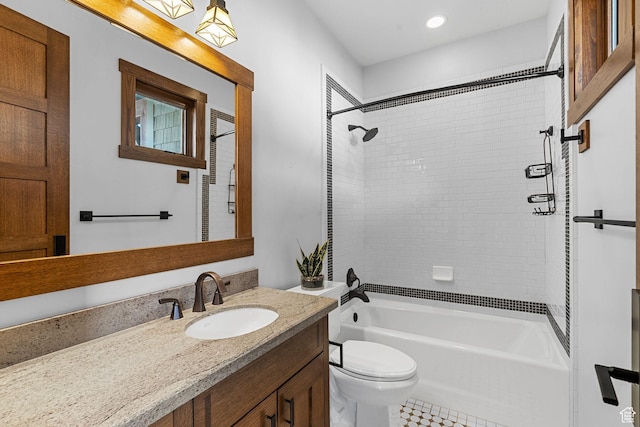 bathroom featuring vanity, toilet, and  shower combination