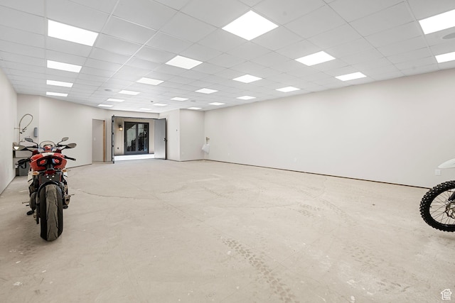 interior space with a paneled ceiling
