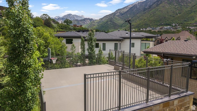 17 S Crosshill Ln, Sandy, UT 84092 - rear view of property featuring a mountain view, concrete driveway, and a patio