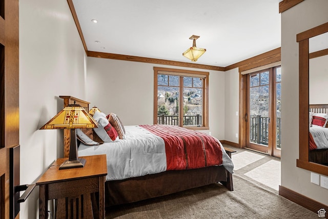 carpeted bedroom featuring access to exterior, multiple windows, baseboards, and ornamental molding
