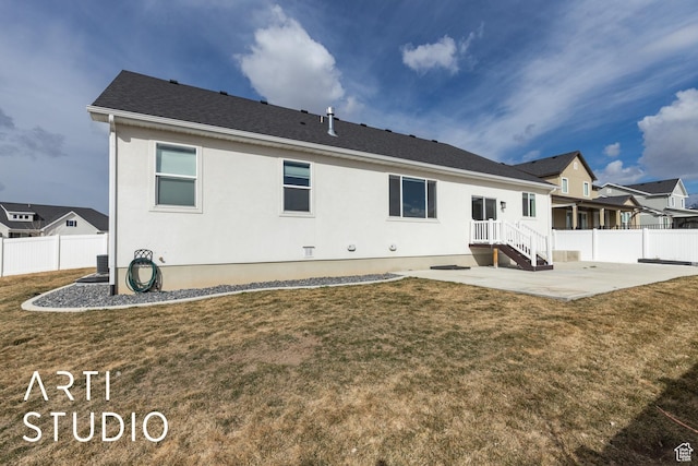 rear view of house featuring a patio area, a yard, and fence