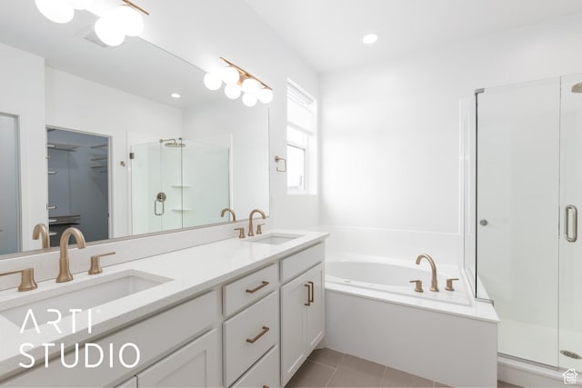 bathroom with a sink, a bath, a shower stall, and tile patterned flooring