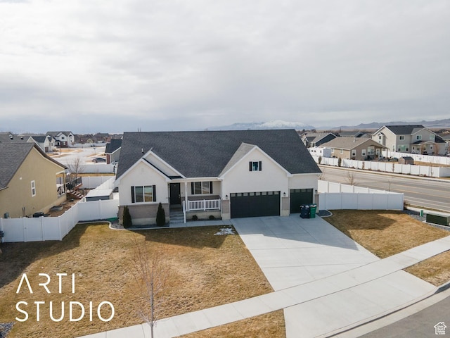modern farmhouse style home with a front yard, fence, a residential view, and driveway