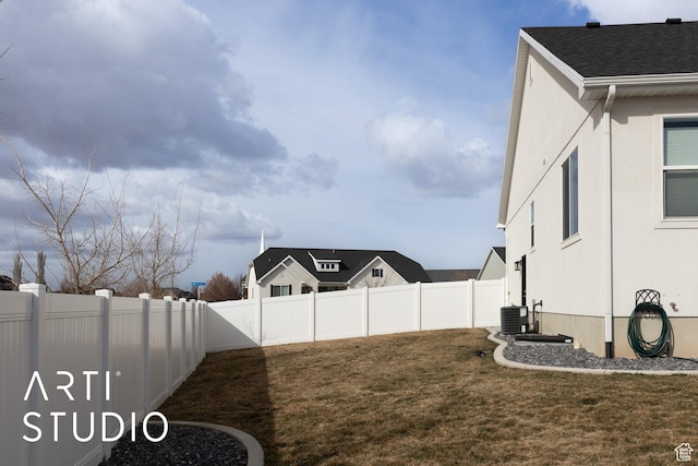 view of yard with central AC unit and a fenced backyard