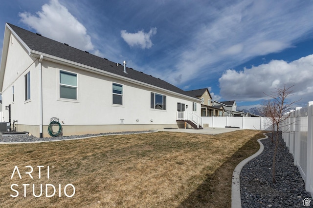 rear view of property featuring stucco siding, a lawn, a patio, a fenced backyard, and a residential view
