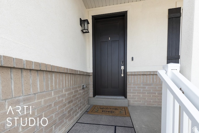 entrance to property featuring stucco siding
