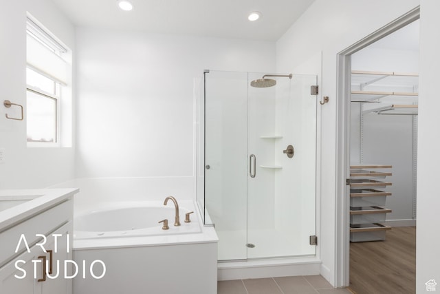 full bathroom with vanity, a shower stall, a garden tub, and recessed lighting