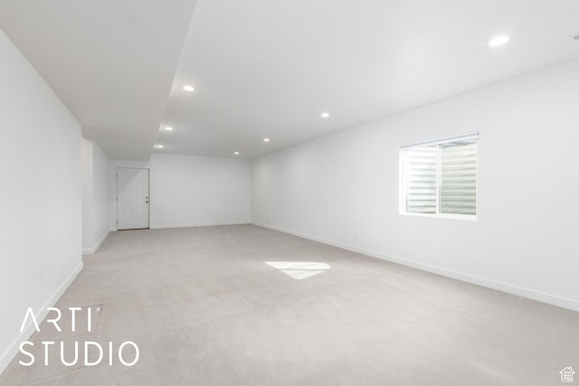 unfurnished room featuring light carpet, recessed lighting, and baseboards