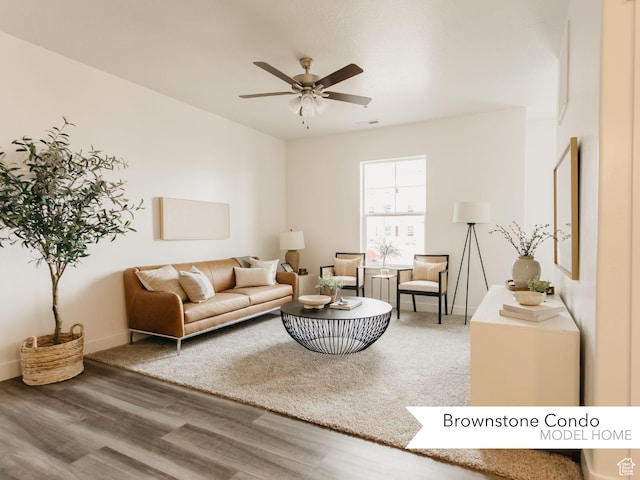living area featuring visible vents, a ceiling fan, and wood finished floors