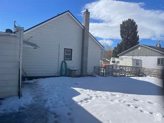 161 E 4th S, Soda Springs, ID 83276 - snow covered property featuring fence and a chimney