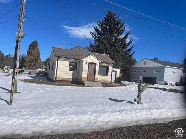 161 E 4th S, Soda Springs, ID 83276 - view of front of home featuring fence and metal roof