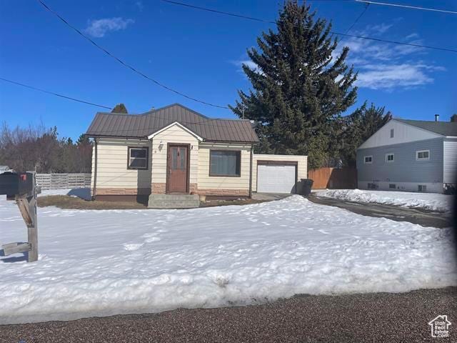 161 E 4th S, Soda Springs, ID 83276 - view of front of property with a garage, fence, and metal roof