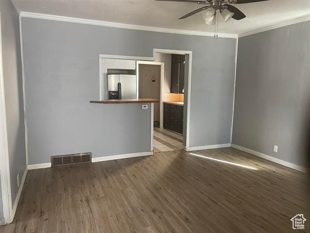 161 E 4th S, Soda Springs, ID 83276 - spare room featuring ornamental molding, visible vents, ceiling fan, and wood finished floors