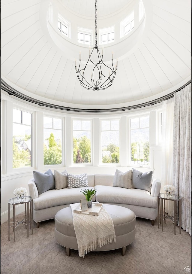 sunroom / solarium featuring lofted ceiling and an inviting chandelier