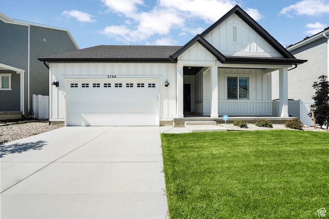 modern farmhouse style home with a garage, driveway, a porch, board and batten siding, and a front yard