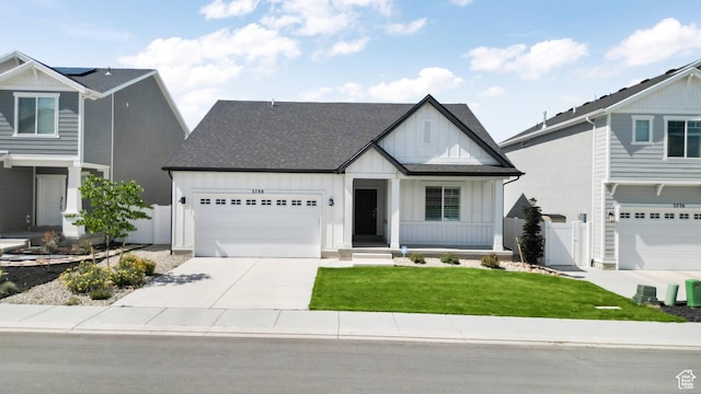 view of front of house featuring an attached garage, a shingled roof, fence, driveway, and board and batten siding
