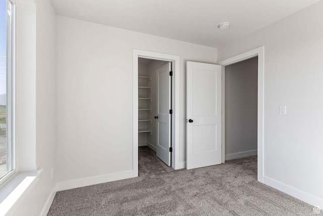 4068 Porter Ave, South Ogden, UT 84403 - unfurnished bedroom featuring carpet, a spacious closet, baseboards, and a closet