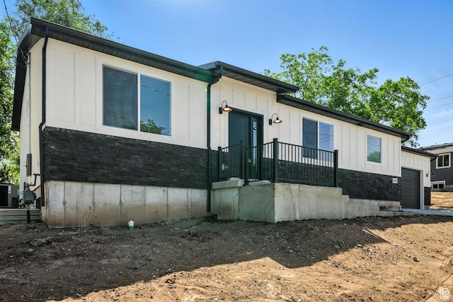 4068 S Porter Ave, South Ogden, UT 84403 - view of front of house featuring an attached garage, board and batten siding, and stone siding