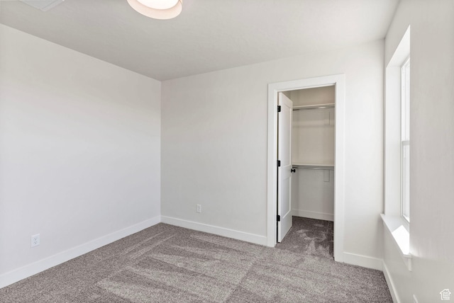 4068 Porter Ave, South Ogden, UT 84403 - unfurnished bedroom featuring carpet flooring, a spacious closet, baseboards, and a closet