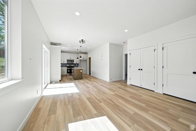 4068 S Porter Ave, South Ogden, UT 84403 - unfurnished living room with light wood-style floors and recessed lighting