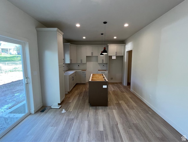 4068 Porter Ave, South Ogden, UT 84403 - kitchen featuring a kitchen island, light wood-style floors, recessed lighting, white cabinets, and baseboards