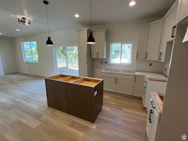 4068 Porter Ave, South Ogden, UT 84403 - kitchen with recessed lighting, a center island, light wood finished floors, hanging light fixtures, and white cabinetry