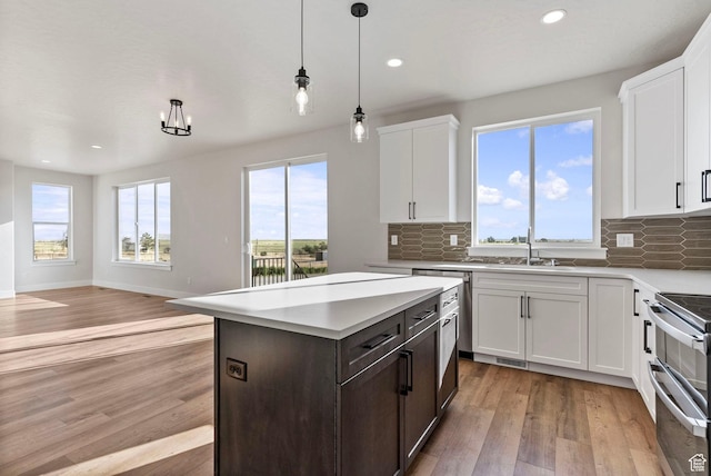 4068 Porter Ave, South Ogden, UT 84403 - kitchen with range with two ovens, light wood-style flooring, light countertops, backsplash, and recessed lighting