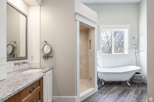 884 E Fence Post Rd S, Fruit Heights, UT 84037 - bathroom with wood finished floors, a freestanding tub, vanity, a tile shower, and backsplash