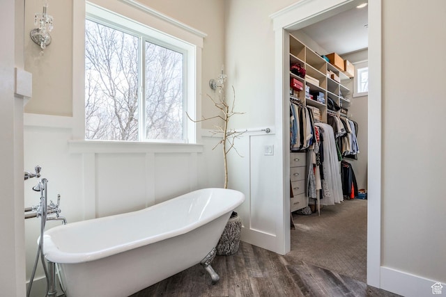 884 E Fence Post Rd S, Fruit Heights, UT 84037 - bathroom featuring a soaking tub, a walk in closet, and wood finished floors