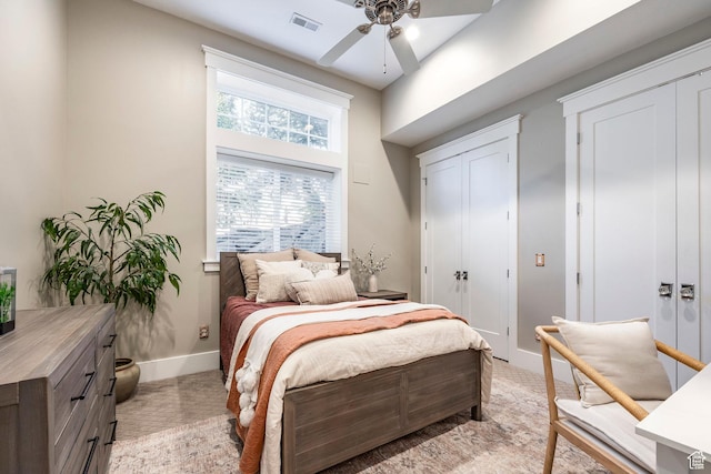 884 E Fence Post Rd S, Fruit Heights, UT 84037 - bedroom featuring ceiling fan, light colored carpet, visible vents, baseboards, and multiple closets
