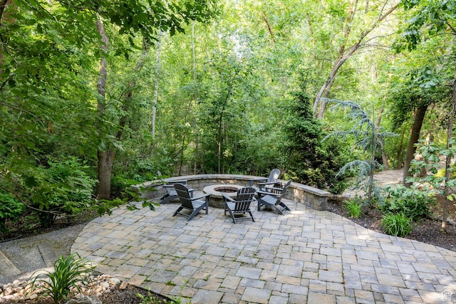 884 E Fence Post Rd S, Fruit Heights, UT 84037 - view of patio / terrace featuring an outdoor fire pit and a wooded view